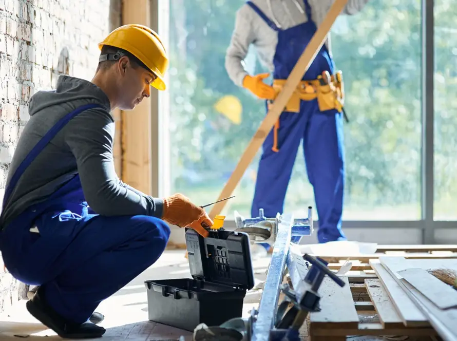 young-male-engineer-taking-instrument-from-toolbox