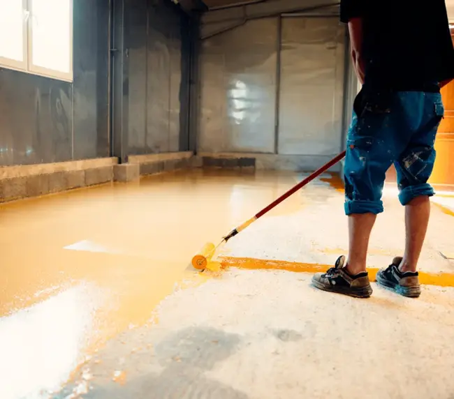 construction-worker-applying-epoxy-resin-coating